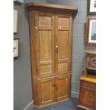 A late Georgian pine freestanding corner cupboard, 211 x 115 cm