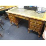 A faded mahogany pedestal partners desk, on cabriole legs, 80 x 152 x 106cm