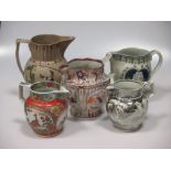 A collection of English pottery jugs to include prattware jugs and a mercury jug