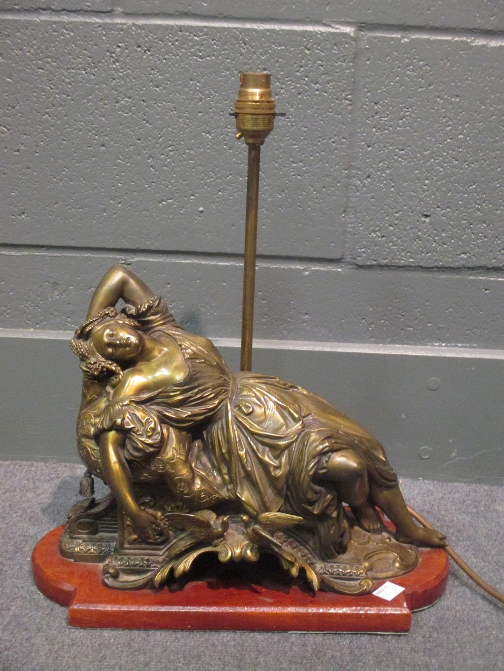 Bronze figural lampbase of a reclining lady