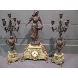 A 19th century spelter clock with garniture on onyx bases