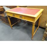 A pair of Edwardian pale oak and red leather inset writing tables with single frieze drawers (2)