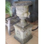 A pair of composition garden urns on square stands, marked 'Sandford Stone', 49cm wide, 115cm high
