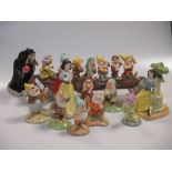Royal Doulton Snow White and the seven Dwarfs figurines together with another Snow White sat upon