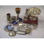 A collection of silver including flatware, napkin rings, decanter lables, two pepperettes, a
