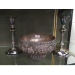 A pair of plated candlesticks and an Indian metal bowl decorated with typical motifs
