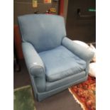 A large blue denim upholstered armchair
