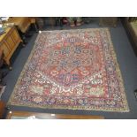 A Heriz pattern large red ground rug 284 x 214cm