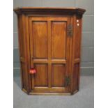 A George III yew wood corner cupboard with butterfly hinged single door, 75cm wide