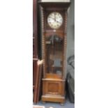 An 8 day oak longcase clock with barley twist column supports on paw feet 201cm high