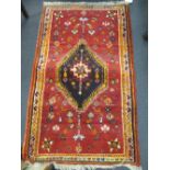 A red ground rug with single medalion together with another rug, 118 x 71cm and 110 x 72cm (2)