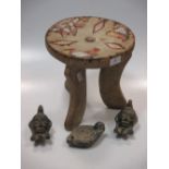 A three footed African stool with bead ornament together with three oil lamps