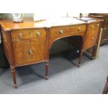 A late Regency mahogany sideboard with slight bowfront and reeded edge over central arch flanked