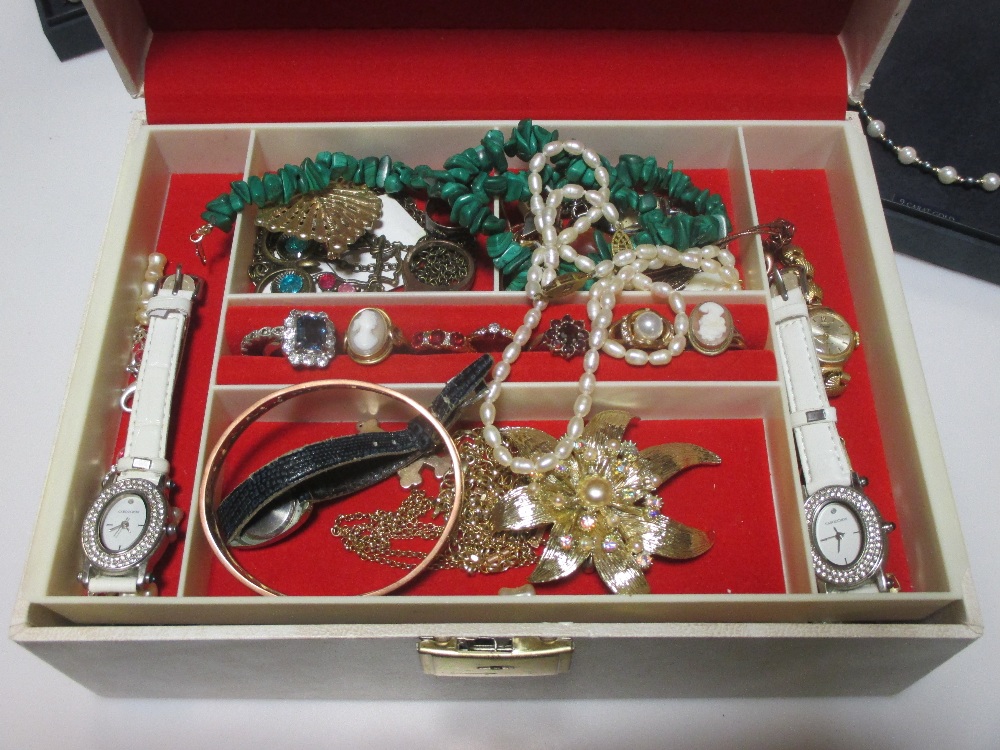 A jewellery box containing a large quantity of costume jewellery, together with two gold crosses