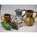 A Bideford pottery puzzle jug and other items of Barnstaple pottery; a collection of unusual green