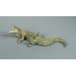 A Bergman cold painted bronze of a crocodile, a removable panel in its back revealing a female