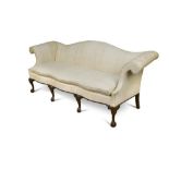 A George III style mahogany sofa, with serpentine shaped back and seat, out-scrolling arms,