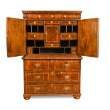 A William and Mary walnut cabinet, with cushion moulded frieze drawer, above two doors with
