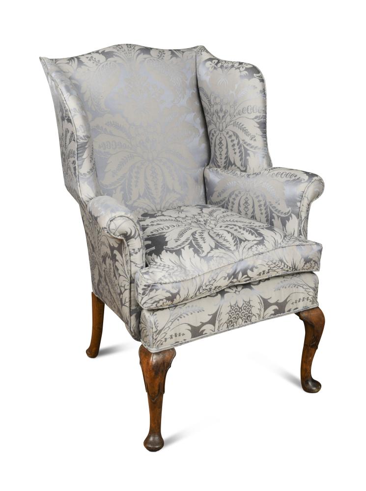 A small George III style wing back armchair, upholstered in a blue damask fabric, loose cushion