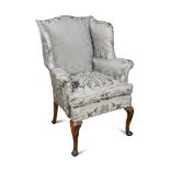 A small George III style wing back armchair, upholstered in a blue damask fabric, loose cushion
