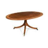 A George III mahogany oval pedestal dining table, crossbanded in rosewood and satinwood, on four