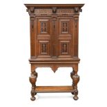 A 17th century style Continental oak cabinet on stand, inlaid with ebony to the frieze and panels,