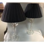 A pair of cut glass table lamps, each of inverted baluster column form with black silk shades (2)