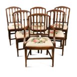 A set of seven Regency mahogany rail back dining chairs, with leaf and florette carved decoration,