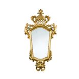 A pair of North Italian giltwood mirrors, with pierced scroll and hooded pediment crestings to