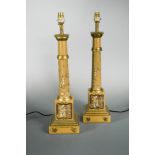 A pair of modern toleware column table lamps, decorated with Chinoiserie scenes on a buff ground,