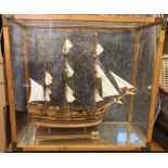 Endeavour' a wooden model ship, within a bespoke glazed display case with brass corners 79 x 86 x