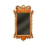 An 18th century fret framed wall mirror, with gilt shell carved cresting and gilded leaf carved