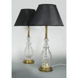 A pair of cut glass table lamps, the cut glass baluster lamps with reeded brass columns supporting