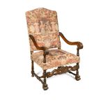 A 17th century Italian style carved oak framed armchair, with needlepoint seat and back, leaf carved