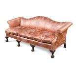 A George III style mahogany frame sofa, with serpentine back and out-scrolling arms, upholstered