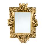 An 18th century giltwood framed mirror, carved with elaborate clusters of leaf and branch to an