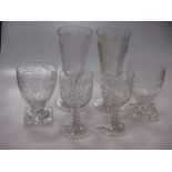 A pair of large 19th century wine glasses in the Gothic taste; A pair of vine decorated rummers