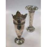 A silver trumpet vase and another silver vase, both loaded