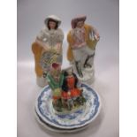 Three Staffordshire flat back figures and two Staffordshire blue and white plates