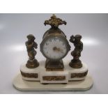 A French gilt brass and white marble mantel timepiece, designed as two children with cymbals and