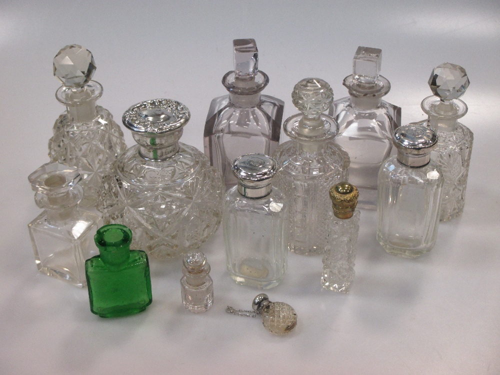 A collection of cut glass scent bottles, three with silver collars (13)