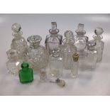 A collection of cut glass scent bottles, three with silver collars (13)