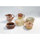 A group of 19th century salt glazed pottery, to include three butter tubs with lion mask handles,