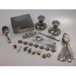 A silver cigarette box, a pair of silver dwarf candlesticks, and some silver jewellery, together