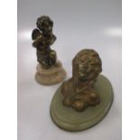 An early 20th century bronze model of a cherub, his hands tied behind his back, together with a