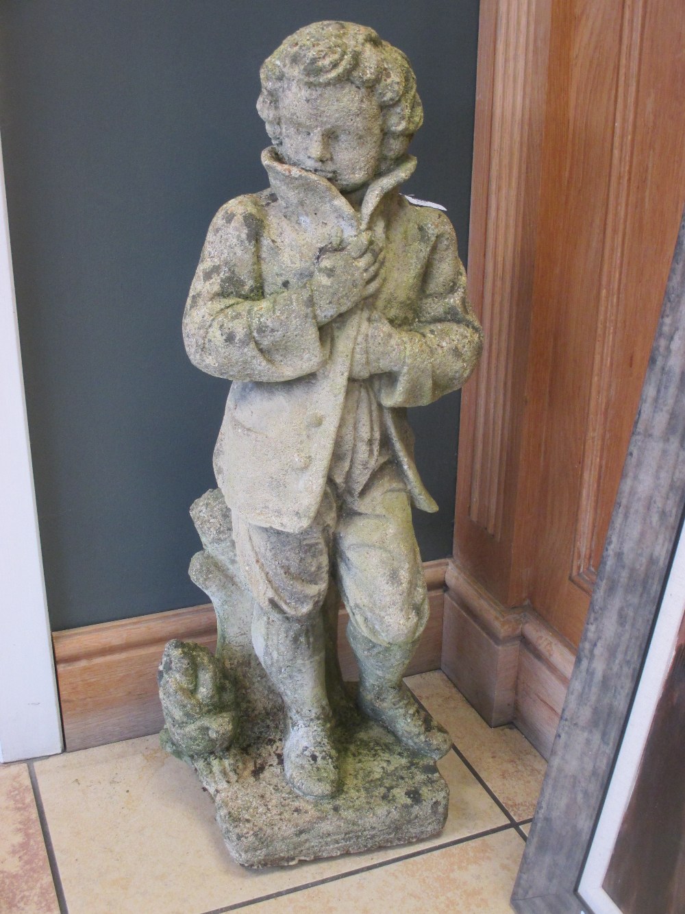 Two composition garden statues: boy 76cm high, figure on stand 128cm high