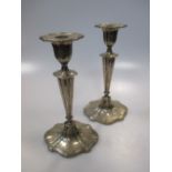 A pair of neo-classical style silver candlesticks by Walker & Hall, Sheffield 1908, loaded