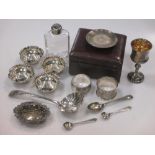 A set of four silver pin trays and another pin tray, together with two napkin rings, four spoons and