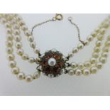 A three row cultured pearl necklace with citrine clasp, the graduated 3.5-7.3mm pearls to a circular
