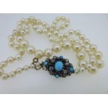 A cultured pearl necklace with antique diamond and turquoise clasp, the single row of graduated 4-